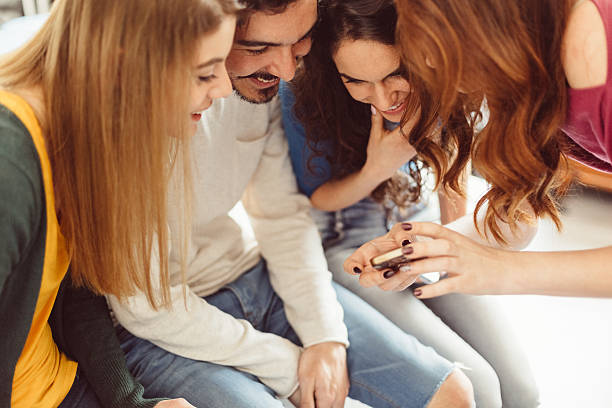 istock Friends enjoying photos on smartphone 618552216
