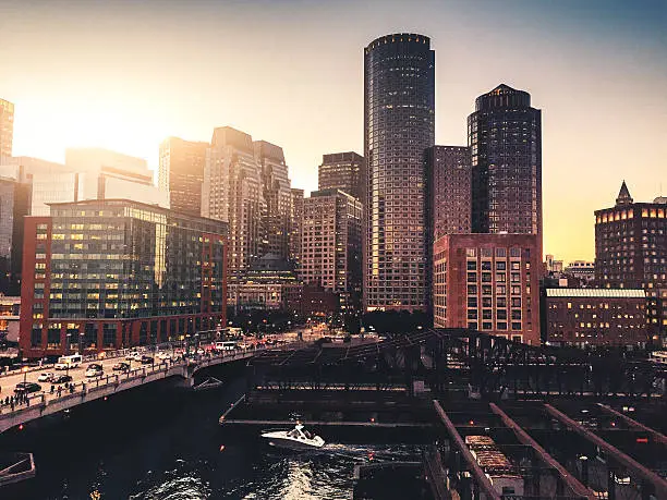 Photo of Boston marina skyline at dusk with sunlight