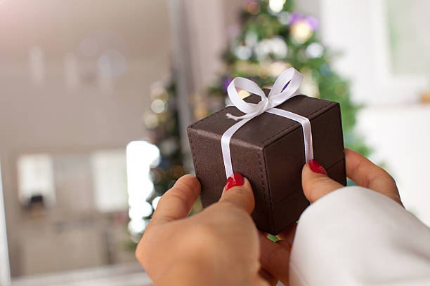shot of female hands holding a small gift box