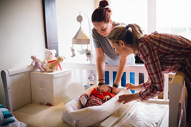 baby naptime - homosexual family lesbian parent imagens e fotografias de stock