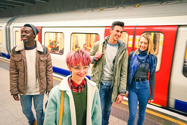 Multiracial group of hipster friends having fun in tube subway Multiracial group of hipster friends having fun in tube subway station - Urban friendship concept with young people walking together in city underground area - Vivid color with focus on pink hair girl ile de france photos stock pictures, royalty-free photos & images