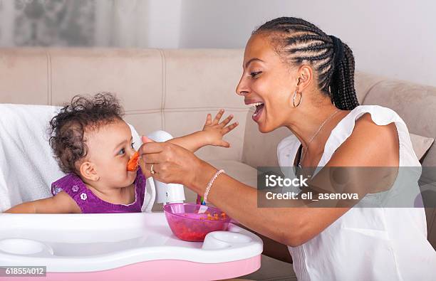 Mother Spoon Feeding Her Baby Stock Photo - Download Image Now - Baby - Human Age, Feeding, Eating