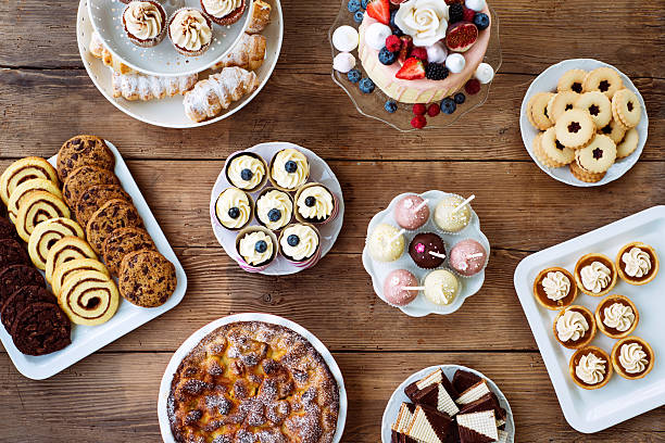 istock Table with cake, pie, cupcakes, cookies, tarts and cakepops 618557602