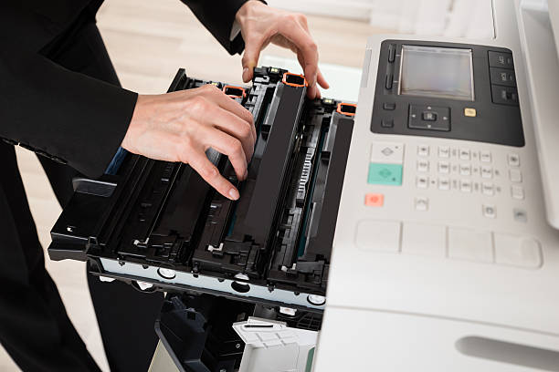 istock Businesswoman Hand Fixing Copy Machine 618557728