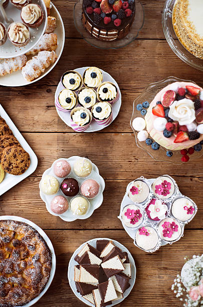 istock Table with loads of cakes, cupcakes, cookies and cakepops. 618557798