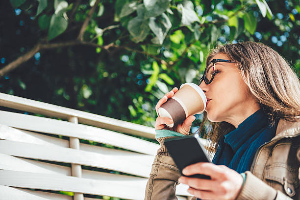 istock Woman drinking coffee outdoors 618608048