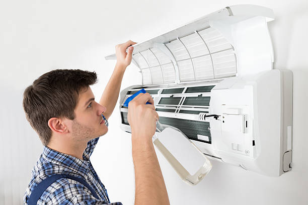 istock Male Technician Cleaning Air Conditioner 618608950
