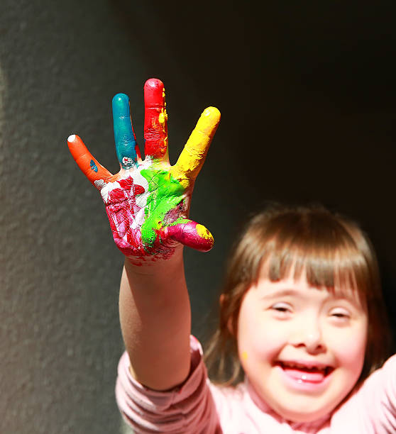 istock Cute little girl with painted hand 618609784