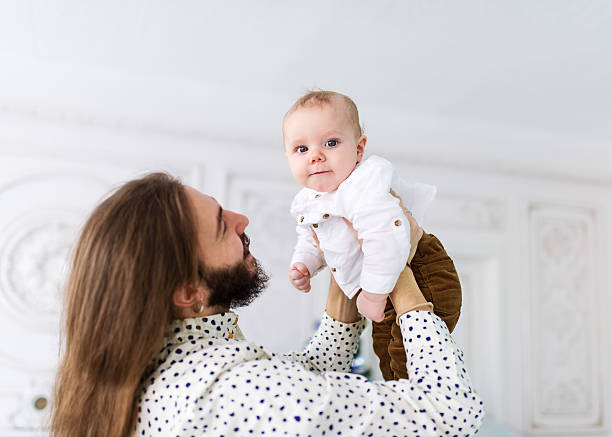 istock Young father and little baby boy are playing 618610042