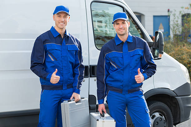 istock Happy Technicians Showing Thumbsup Against Truck 618610216