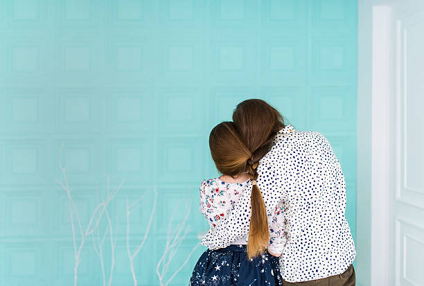 istock The young loving couple sits in the light room. 618610302
