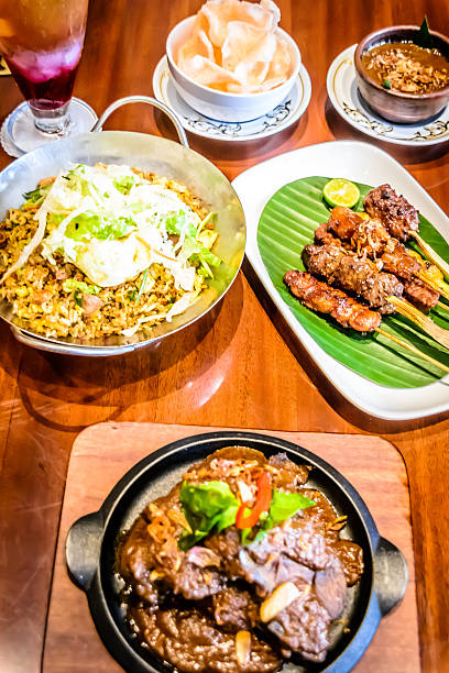 istock fine dining Indonesian dishes spread out over table 618611290