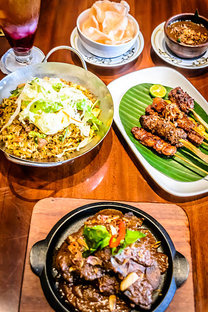 istock fine dining Indonesian dishes spread out over table 618611506