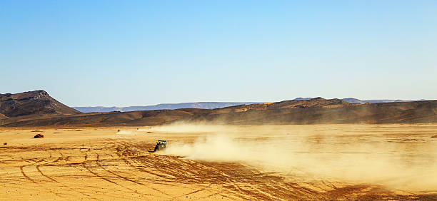 istock off road car with it's pilot in Morocco 618612042