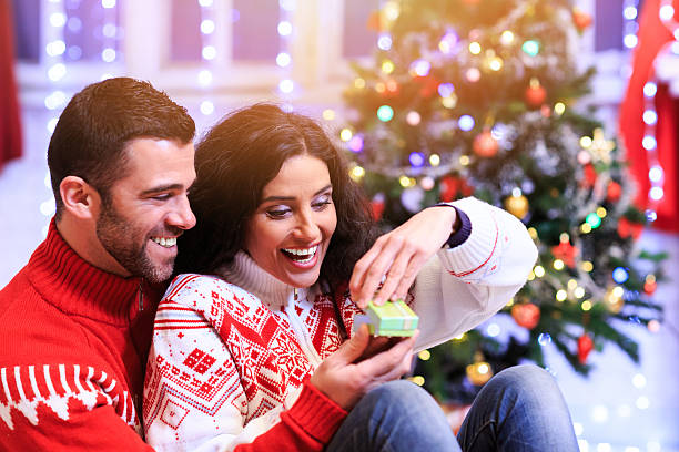 istock Young man surprising his girlfriend on christmas 618613692