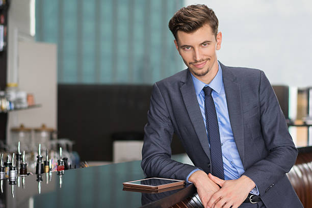 istock Confident Middle-aged Businessman at Cafe Counter 618615044