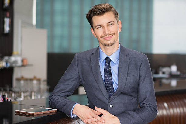 istock Smiling Handsome Businessman at Cafe Counter 618615450