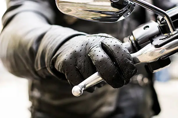 Photo of Biker's hand on brake lever handlebar