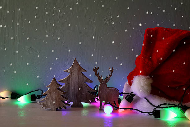 istock hristmas tree and deer next to santa hat 618616220
