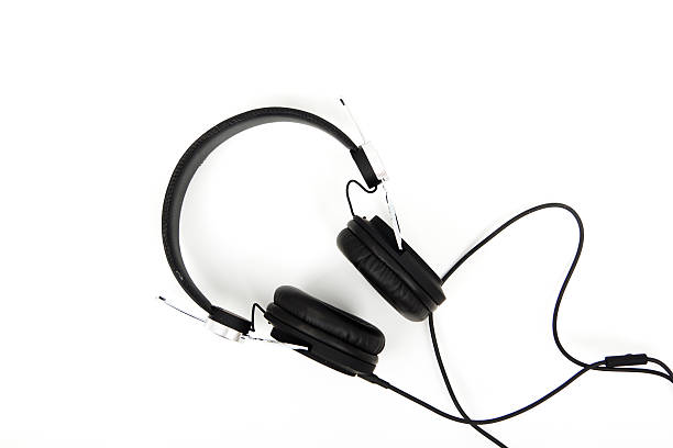 istock Black headphones against a light coloured background 618616302