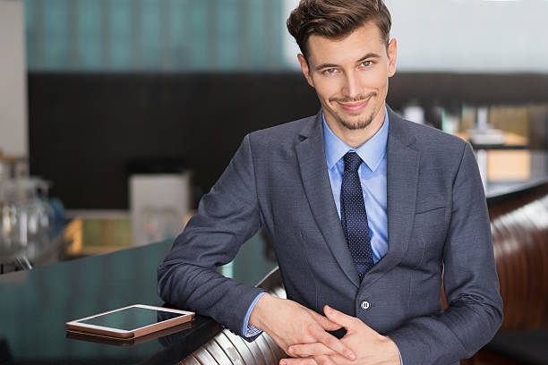 istock Amusing Young Businessman Standing at Cafe Counter 618618272