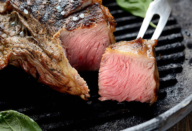 istock grilled beef steak and basil in a pan 618622260