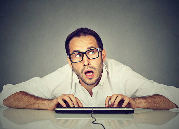 istock Man typing on keyboard wondering what to reply 618625686