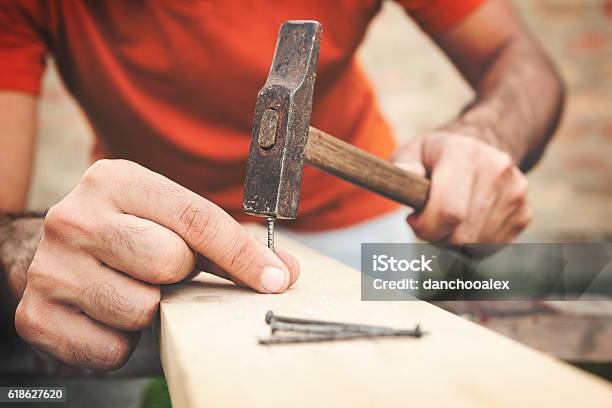Hammer Nails And Hands Close Up Shot Stock Photo - Download Image Now - Hammer, Nail - Work Tool, Wood - Material
