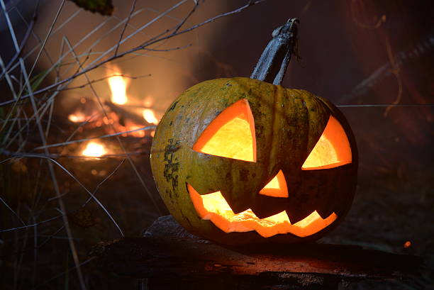istock flaming halloween pumpkin head jack with fire on the background 618628654