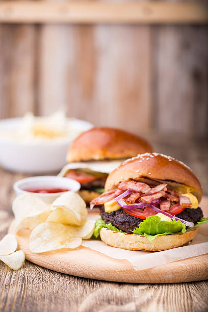 istock Burgrers with bacon on wooden board 618629322