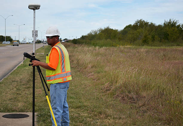 istock Surveyor In Safety Gear Working With Equipment 618630204