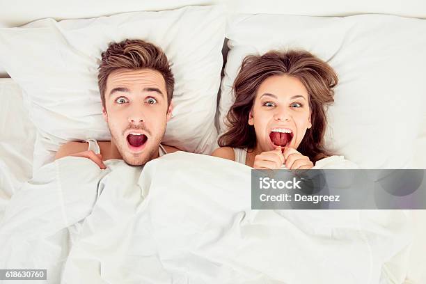 Surprised Funny Couple In Love Lying In The Bed Stock Photo - Download Image Now - Sex and Reproduction, Couple - Relationship, Humor