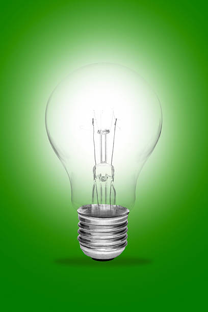 istock idea concept whit one glowing light bulb on green background 618630940