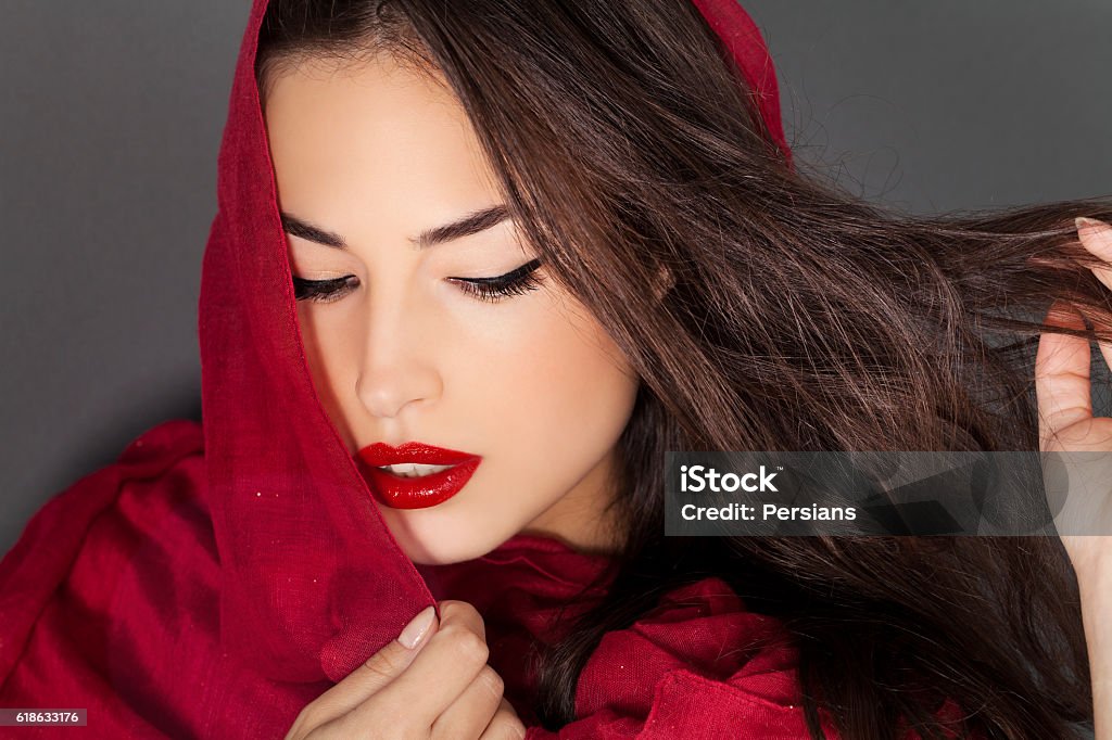 classic beauty with red lips and scraf beautiful woman portrait with red lips and red veil over her head, studio shot Diva - Human Role Stock Photo