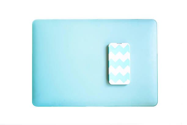 Blue and white mobile phone on the laptop isolated stock photo