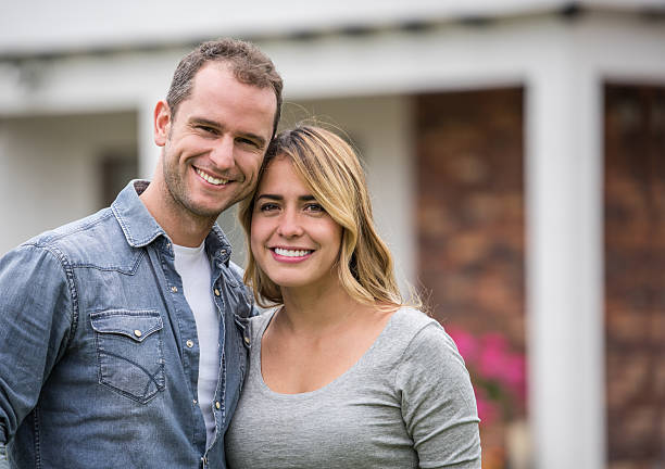 istock Happy couple outside their house 618635364