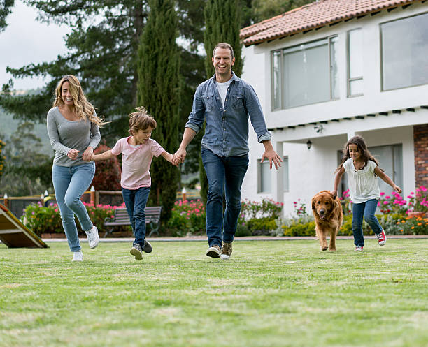 istock Happy family having fun outdoors with their dog 618635458