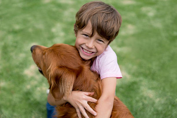 istock Happy boy playing with his dog 618635480