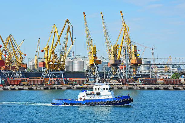 istock Tugboat and port cargo crane 618636188