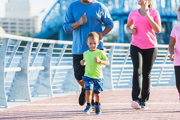 istock Little boy exercising with his family 618637176