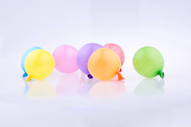 istock Colorful small balloons on a white background 618637260