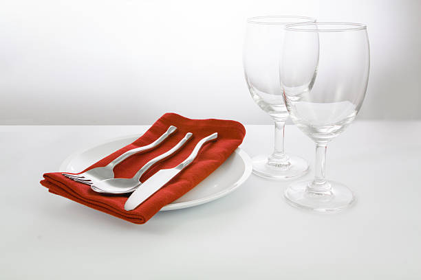 istock fork and knife on red napkin and wine glasses 618637690