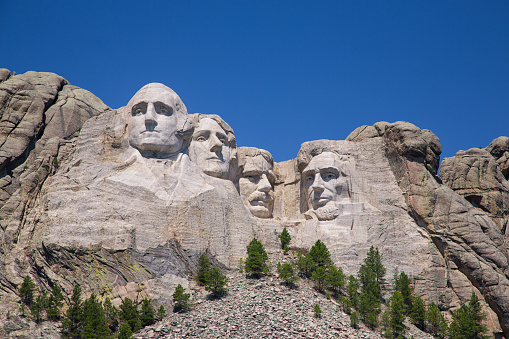 Great detail and textures of Mount Rushmore with blue sky.