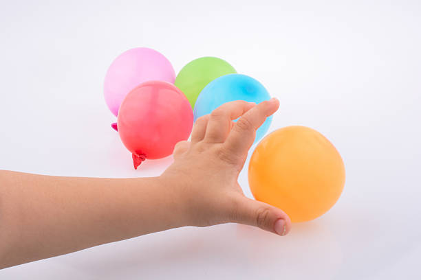 istock Hand holding a Colorful small balloon in hand 618637718