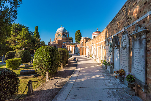 Venice, Italy - October 21, 2016: One of the most beautiful and least visited of Venice is its monumental cemetery, which occupies the entire island of San Michele. The island is located between Venice and Murano Cannaregio. The cemetery is divided into various areas housing the remains of some famous people such as Igor Stravinsky and Ezra Pound. Initially the island was divided in two, but in the course of 1800 was buried the channel that separated the two islands to create a single. In this photographic tour you can see some details of tombs and interesting architecture.