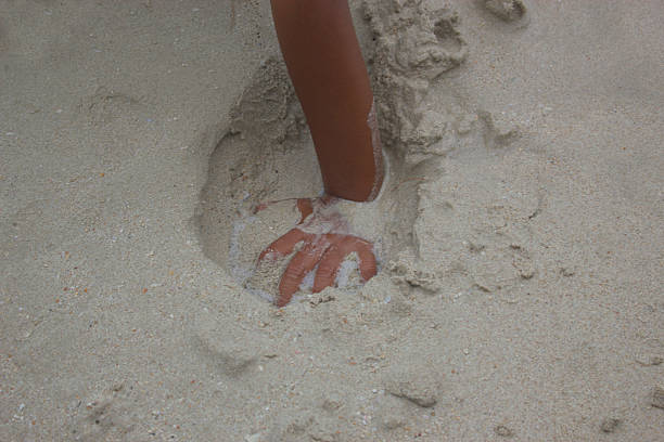 istock Asian child playing with sand in the beach. 618640176
