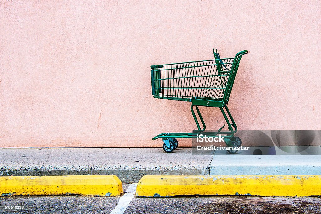 Abandoned Shopping Cart Abandoned Shopping Cart against Pink Wall Shopping Cart Stock Photo
