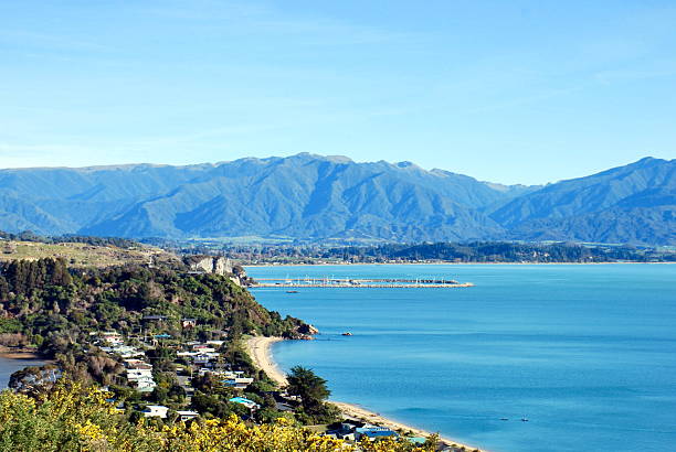 Across Golden Bay from Wainui Hill, Tasman District, New Zealand Looking down from Wainui Hill across Tata Beach and Golden Bay to the distant Kahurangi Ranges, Near Takaka in the Tasman District on New Zealand/ Aotearoa's South Island. nelson city new zealand stock pictures, royalty-free photos & images