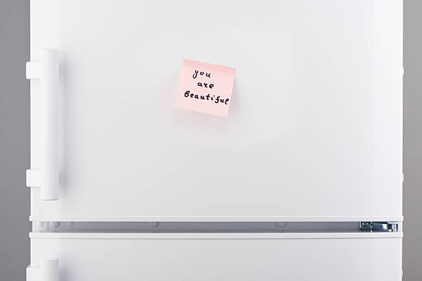 istock You are beautiful note on pink paper on white refrigerator 618641962