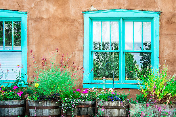 istock Santa Fe Blue Windows on Stucco Wall with Flowers 618642222